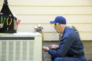 Technician installing one of the HVAC units best HVAC brands at a home.