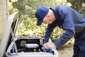 HVAC technician working to install a new HVAC system for a new homeowner.